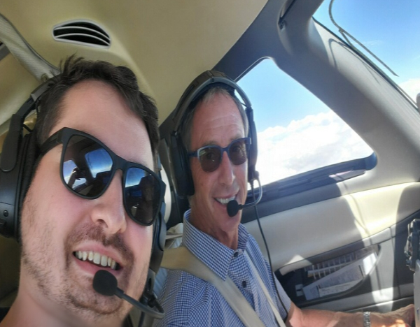 Hans Fuegi and mission assistant Evan, from the Westminster Rotaract club, on an AFW flight. 
