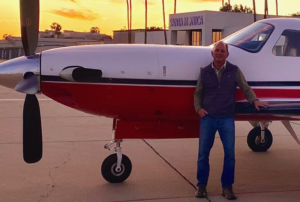 Rob Ross in front of his small plane
