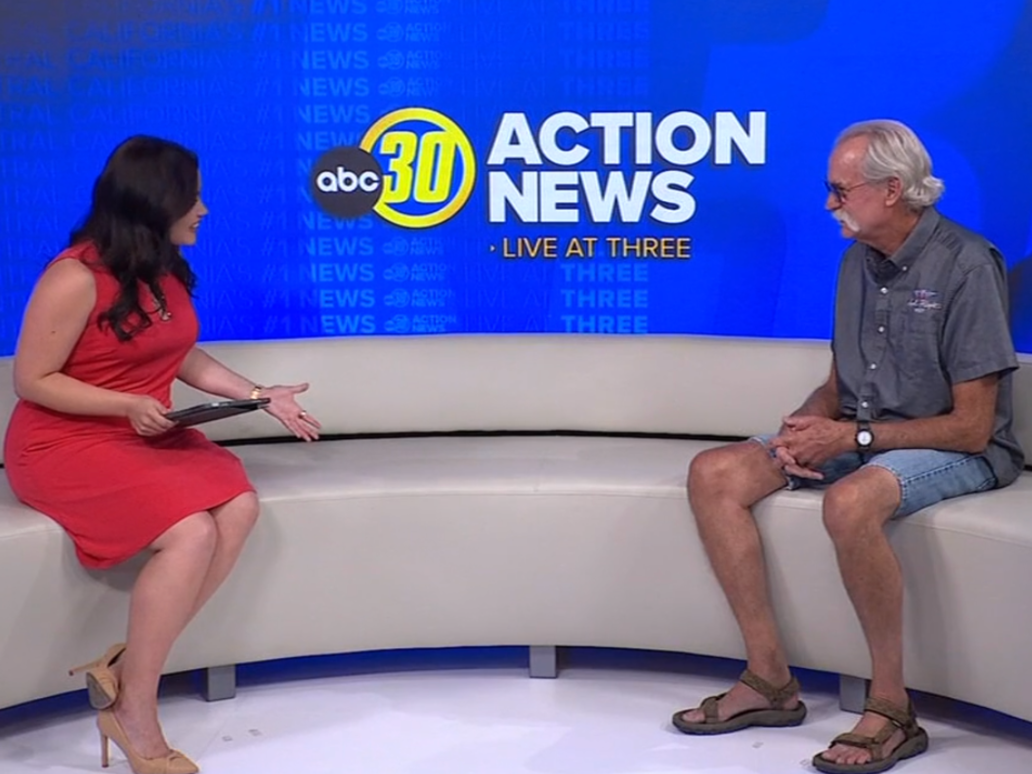 A news anchor interviews a man on the ABC30 Action News "Live at Three" set.
